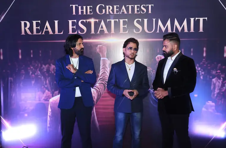 Dev Gadhvi on stage with a guest at a previous summit