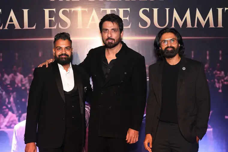 Dev Gadhvi and CA Mayur Mehta with a guest at a previous summit